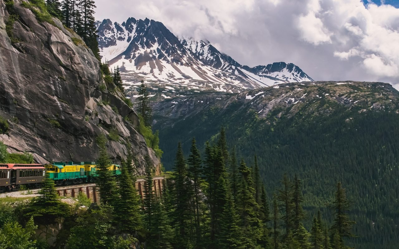 A White Pass & Yukon Route train below snow-capped peaks near Skagway